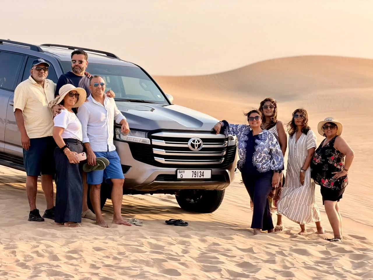 Group with a Toyota Land Cruiser in the Abu Dhabi desert during an evening safari